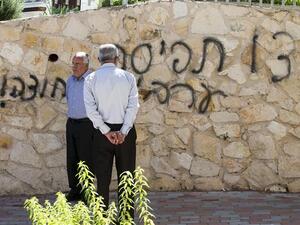 Arab Israeli men stand next to graffiti reading in Hebrew "Arabs Out" on the wall of a mosque in the northern Israeli city of Umm al-Faham. AFP Photo
 Arab Israeli men stand next to graffiti reading in Hebrew "Arabs Out" on the wall of a mosque in the northern Israeli city of Umm al-Faham. AFP Photo