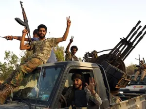 Members of the Salah Bou-Haliqa brigade celebrate as they arrive in the eastern city of Benghazi. (AFP Photo)