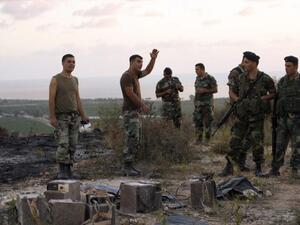 Lebanese soldiers stand next to the remains of an Israeli spy device on September 5, 2014 near the village of Adloun in southern Lebanon. (AFP/Mahmoud Zayyat)
