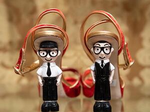 Shoes with the heels made out of figurines representing Italian fashion designers Domenico Dolce (left) and Stefano Gabbana are displayed at a store in Beijing (AFP)