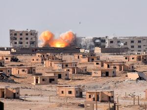Smoke rises from buildings in the area of Bughayliyah, on the northern outskirts of Deir Ezzor city. (AFP/ George OURFALIAN)
