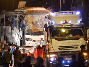 A tourist bus which was hit by a deadly bombing being towed away from the scene in Giza province south of the Egyptian capital Cairo (AFP)