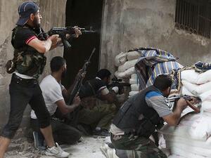 Fighters of the Free Syrian Army exchange fire with regime forces in Aleppo. (AFP/File)