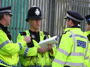 British police officers deliberating (AFP/File Photo)	
