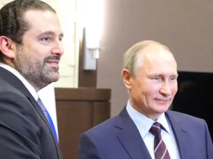 Russian President Vladimir Putin, right, shakes hands with Lebanese Prime Minister Saad Hariri during a meeting in Sochi on Wednesday. (AFP)