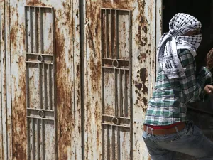A Palestinian protester wearing the traditional chequerred keffiyeh (AFP)