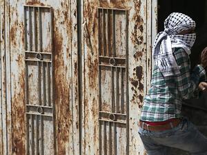 A Palestinian protester wearing the traditional chequerred keffiyeh (AFP)
