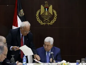 Palestinian president Mahmoud Abbas (R) speaks with Palestine Liberation Organization's Secretary General Saeb Erekat during a meeting of the Palestine Liberation Organization (PLO) (AFP)