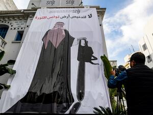 This picture taken on November 26, 2018 shows a giant banner hanging at the headquarters of Tunisia's Journalists Union in the capital Tunis depicting a cartoon of Saudi Crown Prince Mohammed bin Salman (AFP)