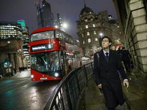 A red London bus makes it's way through the City of London (AFP)