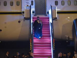 Saudi Crown Prince Mohammed Bin Salman looks on as he descends the plane upon arriving at the airport in New Delhi 
Money SHARMA / AFP