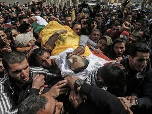Palestinian mourners carry the body of Mousa Mousa,23, during his funeral in Deir al-Balah in the central Gaza Strip (AFP) Palestinian mourners carry the body of Mousa Mousa,23, during his funeral in Deir al-Balah in the central Gaza Strip (AFP)