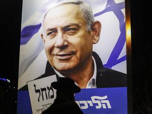 An Ultra-Orthodox Jewish man passes by a billboard showing a Liked Party electoral billboard depicting Israeli Prime Minister Benjamin Netanyahu in Jerusalem on April 7, 2019, two days ahead of the parliamentary polls. 
Ahmad GHARABLI / AFP