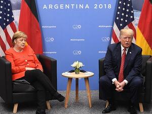 Angela Merkel looks less than impressed with Donald Trump during a meeting at the G20 Summit in Buenos Aires (AFP)
