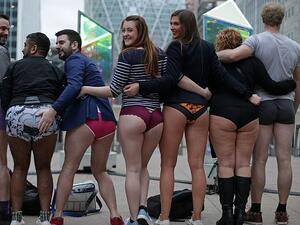 Another group posed at Canada Wharf as they took part in the No Trousers On The Tube event (AFP)