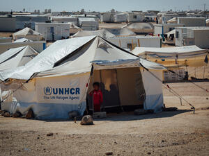Syrian child standing outside her tent at the Zaatari Refugee camp in Mafraq, Jordan (Shutterstock)