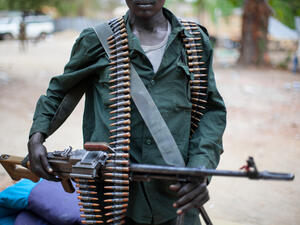 Sudanese soldier carries a machine gun (Shutterstock)