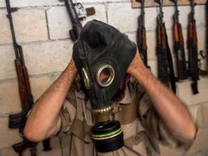 A Syrian rebel tries on a gas mask in the northwestern province of Idlib, on July 18, 2013. (AFP/File)