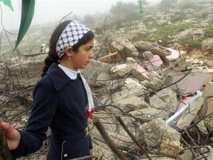 A Palestinian girls looks at the remains of her demolished home. (AFP/File)