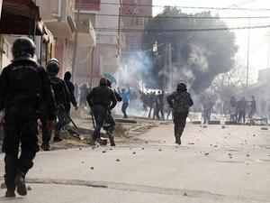 Anger grew over the death of a journalist who set himself on fire over economic conditions, prompting clashes to spread from an impoverished western city overnight. (AFP)