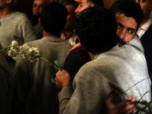 Iranian men who had been held hostage by Syrian rebels since early August hug each other as they arrive at a hotel in Damascus after being freed in a prisoner swap. (AFP PHOTO/LOUAI BESHARA)