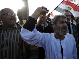 Egyptian anti-government protestors shout political slogans as they wave their national flag and banners during a march towards Cairo's landmark Tahrir. (AFP PHOTO/GIANLUIGI GUERCIA)