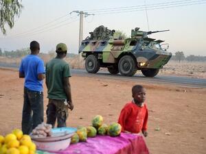 Malian people look at a French armoured vehicle as French soldiers leave Bamako and start their deployment to the north of Mali as part of the "Serval" operations on Tuesday. (AFP PHOTO/ ERIC FEFERBERG)