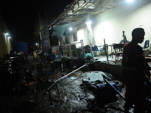 A man walks near the site of a car bomb explosion in Mogadishu on August 5, 2018. At least three were killed and five others injured after car bomb exploded outside a popular restaurant. (Mohamed ABDIWAHAB / AFP)