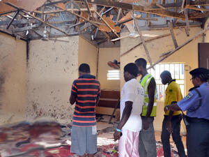 People standing in a mosque following a suicide bombing in northeast Nigeria. (AFP Photo/Stringer)

