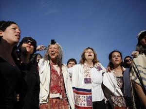 Members of the liberal Jewish religious group Women of the Wall wear phylacteries and the "Tallit" shawl, traditional Jewish prayer apparel for men, as they pray at the Western Wall in Jerusalem's Old City on Friday. AFP Photo