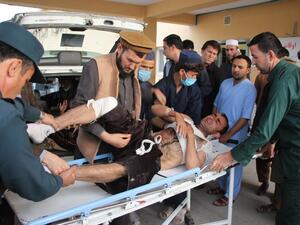 Afghan volunteers transport an injured man on a stretcher to a hospital following a bomb attack in Taloqan in northeastern Takhar province on October 13, 2018. (NASEER SADEQ / AFP)