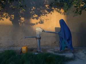 An Afghan woman collects water from pump. (AFP) 