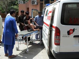 Afghan volunteers carry an injured youth on a stretcher to a hospital following an attack that targeted an education department on July 11, 2018. (AFP/ File)