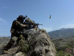 In this photograph taken on April 11, 2017, an Afghan security force personnel fires during an ongoing an operation against Daesh militants in the Achin district of Nangarhar province. (AFP/Noorullah Shirzada)