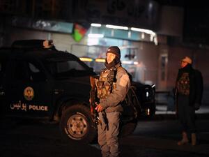 This picture taken on January 10, 2017 shows Afghan policemen standing guard at the site of an explosion near the governor's compound in Kandahar. (AFP/Jawed Tanveer)