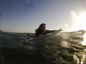 Afghan surfer Afridun Amu paddles out to catch a wave in preparation for the World Surfing Games in Biarritz. (AFP/File)