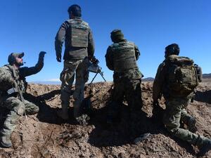 In this photograph taken on February 9, 2017, an Italian soldier from NATO's Resolute Support Mission (L) trains Afghan National Army (ANA) soldiers at a Military Training centre on the outskirts of Herat. (AFP/Aref Karimi)