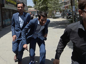 Afghan residents run at the site of a suicide blast near Iraq's embassy in Kabul. (AFP) 