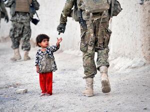 An Afghan girl greets a joint patrol of US troops from the Charlie Company. (AFP/ File)