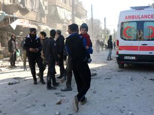 Syrians gather at the site following a reported air strike on the rebel-held neighbourhood of al-Kalasa in the northern Syrian city of Aleppo, on February 4, 2016. (AFP/Thaer Mohammed)