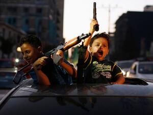 Palestinian children hold guns as they celebrate ceasefire agreement  (Twitter)
