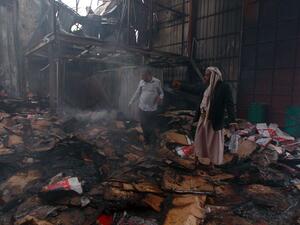 Employees check the damage at a food factory in Yemen's rebel-held capital Sanaa, after it was hit by a Saudi-led coalition strike on August 9, 2016. (AFP/Mohammed Huwais)

