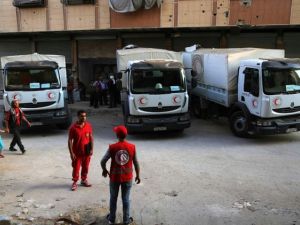 A source said sealed aid trucks coming from Turkey to Aleppo would be opened inside the city by the Syrian Red Crescent, which would distribute the aid. (AFP/Amer Almohibany) 