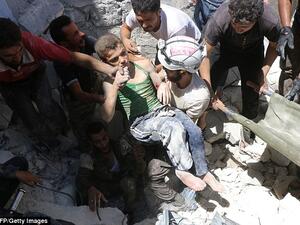 Rebel-held neighbourhoods of Aleppo have been effectively besieged by regime forces backed up by Russian air power since July 7. A boy is lifted from the rubble after an air strike. (AFP/File) 