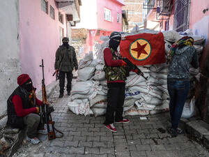 A flag of Kurdish workers Party (PKK) hangs on a barricade as armed Kurdish militants man a barricade, on 18 November 2015 in the Sur district of Diyarbakir. (AFP/File)
