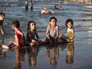 Palestinian children play on the beach in Gaza city. (AFP/File) 