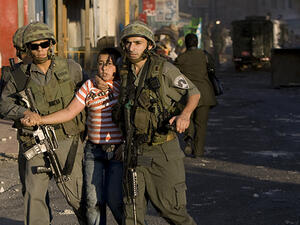 Israeli border policemen detain a Palestinian boy in the east Jerusalem Shuafat refugee camp. (AFP/Jonathan Nackstrand)
