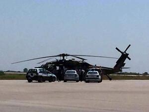 Greek police vehicles next to a Turkish military helicopter at Alexandroupolis airport, after it landed there carrying eight officers seeking asylum after a coup bid in Turkey, on July 16, 2016 (AFP/File)