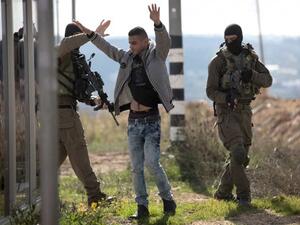A Palestinian is checked by Israeli soldiers at the Gush Etzion junction on the main road between Jerusalem and Hebron. (AFP/File)