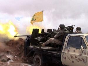 A Hezbollah fighter fires towards Syrian rebel areas on the Syrian side of the Qalamun hills close to the Lebanese border on May 16, 2015. (AFP/File) 